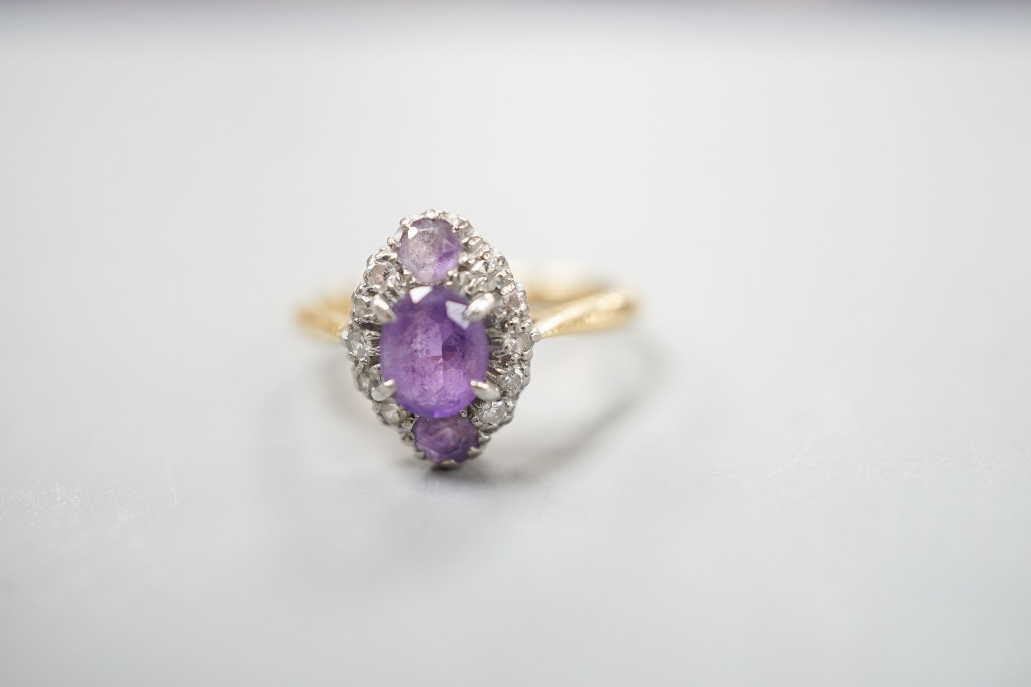 An early 20th century 18ct & plat, amethyst and diamond set marquise cluster ring, size K, gross weight 3.2 grams.